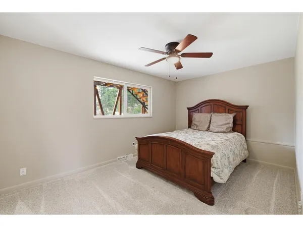 a bedroom with a bed and a painting on the wall