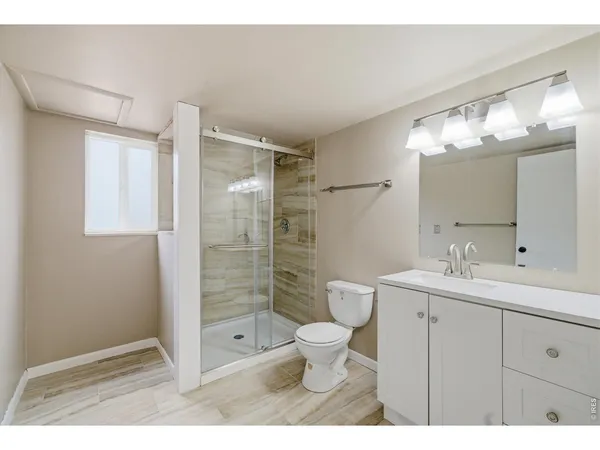a bathroom with a double vanity sink toilet and shower