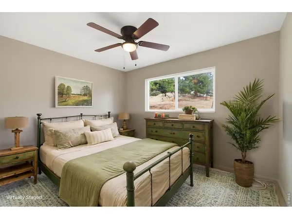 a bedroom with a large bed and a potted plant