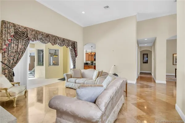 a kitchen with stainless steel appliances granite countertop a sink refrigerator and cabinets