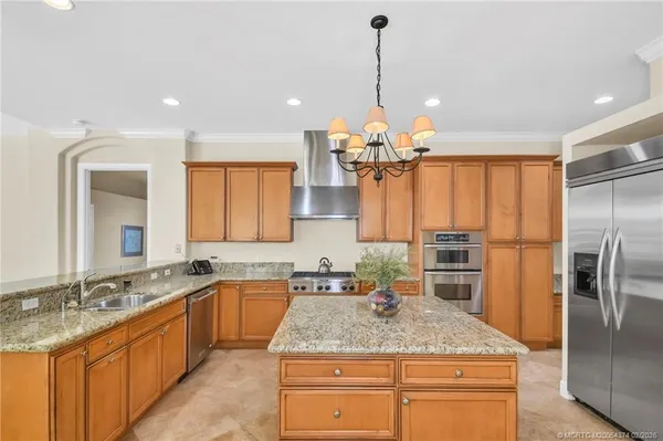 a kitchen with stainless steel appliances granite countertop a stove oven and a sink with cabinets