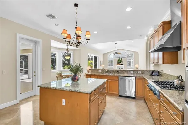 a kitchen with stainless steel appliances granite countertop a sink counter space cabinets and a large window