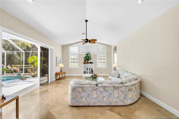 a living room with furniture and kitchen view