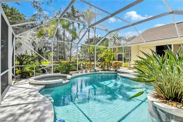 a view of swimming pool with outdoor seating