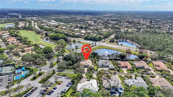 an aerial view of a house with a swimming pool yard and lake view