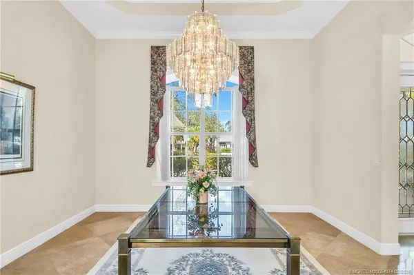 a living room with furniture and a chandelier