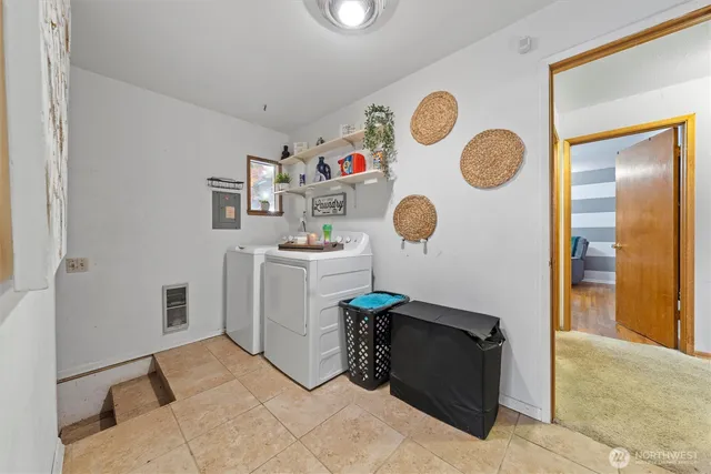 a living room with a table and a clock