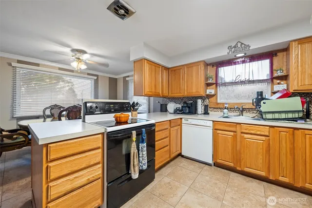 a kitchen with stainless steel appliances granite countertop sink stove and refrigerator