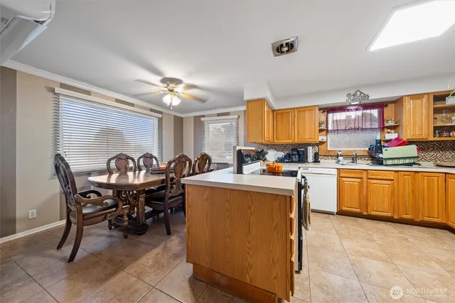 a kitchen with a table chairs and a refrigerator