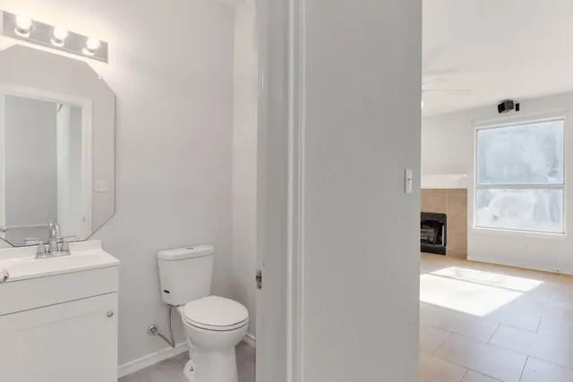 a bathroom with a toilet a sink and a mirror