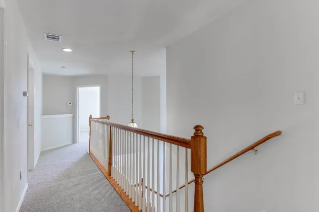 a view of a hallway with stairs