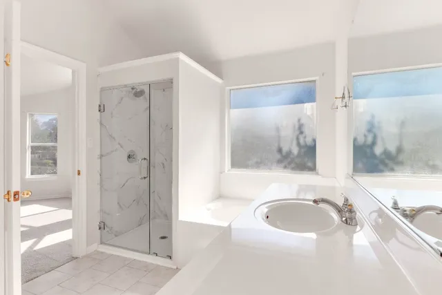 a bathroom with a bathtub and a shower