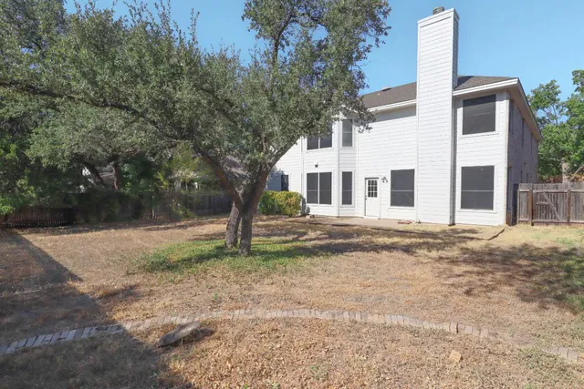 a house that has a tree in front of it