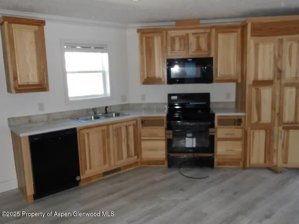 a kitchen with a stove microwave and a sink