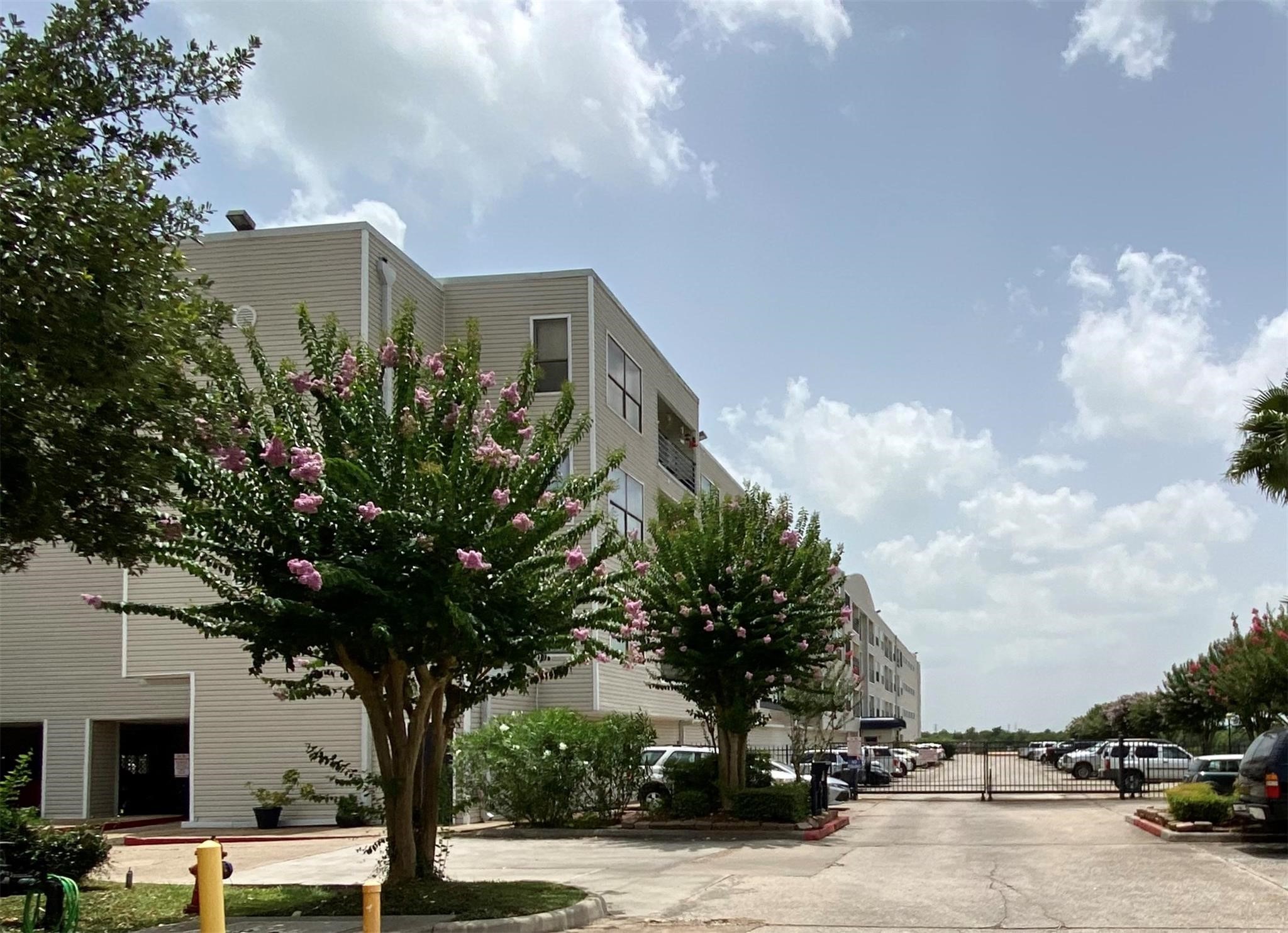 793 Davis Road, Unit 111 League City, TX 77573 - Photo 11 of 16 Gated entrance to outside parking. Garage parking entrance seen to the left. This unit has one assigned parking space in the garage.