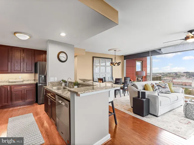 a kitchen with sink refrigerator and large window
