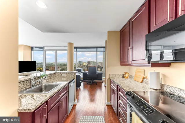 a view of a workspace with furniture and a floor to ceiling window