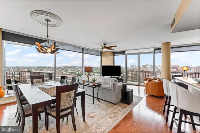a bedroom with a bed a mirror and a large window