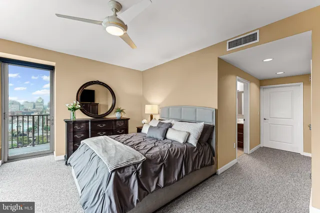 a spacious bathroom with a double vanity sink toilet mirror and shower
