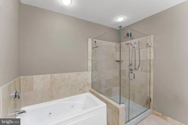 a bedroom with a bed and a lamp on dresser