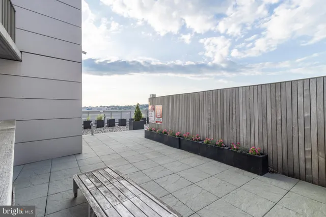 a view of roof deck with a barbeque oven and seating space