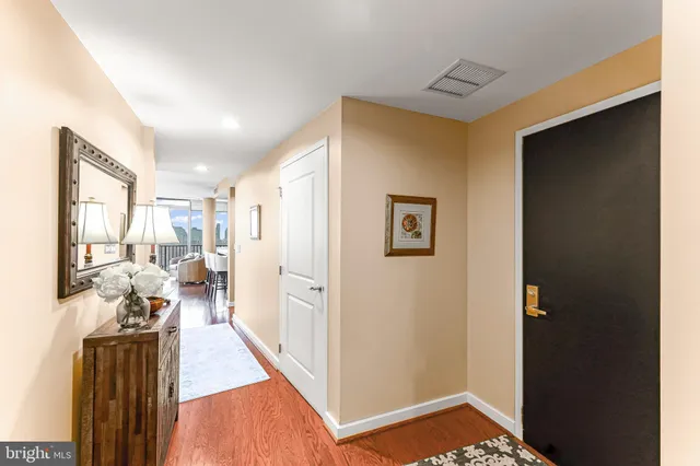 a living room with furniture a flat screen tv and a floor to ceiling window