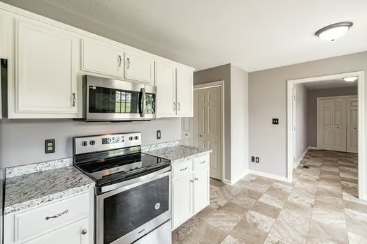 2029 Copper Kettle Circle Pleasant View, TN 37146 - Photo 23 of 58 a kitchen with stainless steel appliances granite countertop a stove microwave and refrigerator