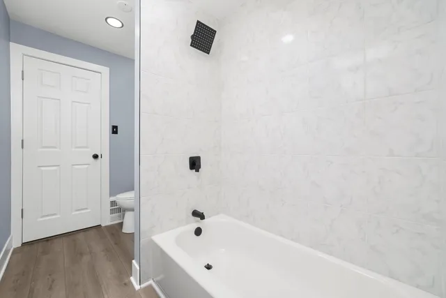 a bathroom with a bathtub and a toilet