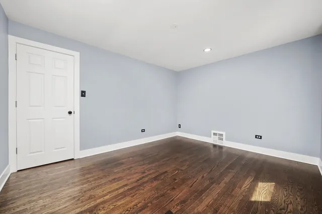 a view of room with wooden floor and natural light