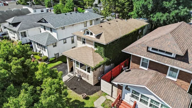 an aerial view of multiple houses with a yard