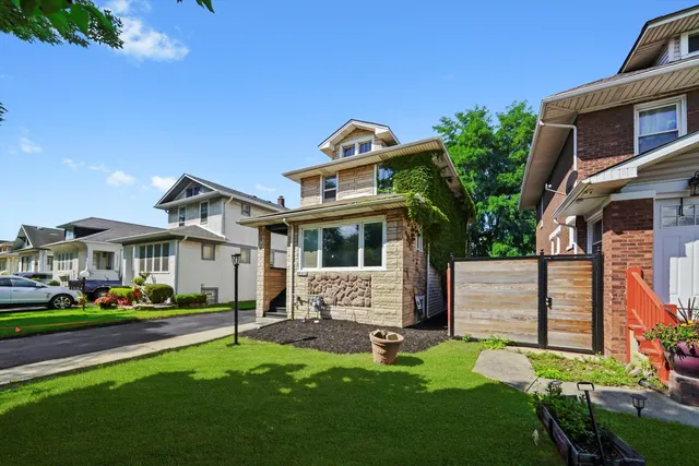 a front view of a house with a yard table and chairs
