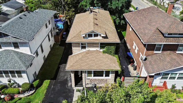 an aerial view of a house with a yard