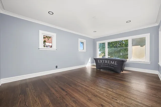 a room with window a ceiling fan and wooden floor