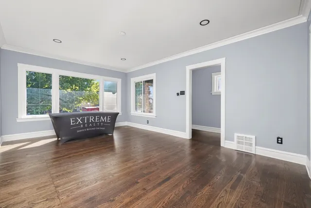 a view of a room with wooden floor and windows
