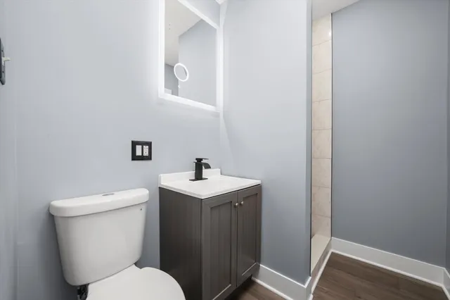 a white toilet sitting next to a bathroom sink