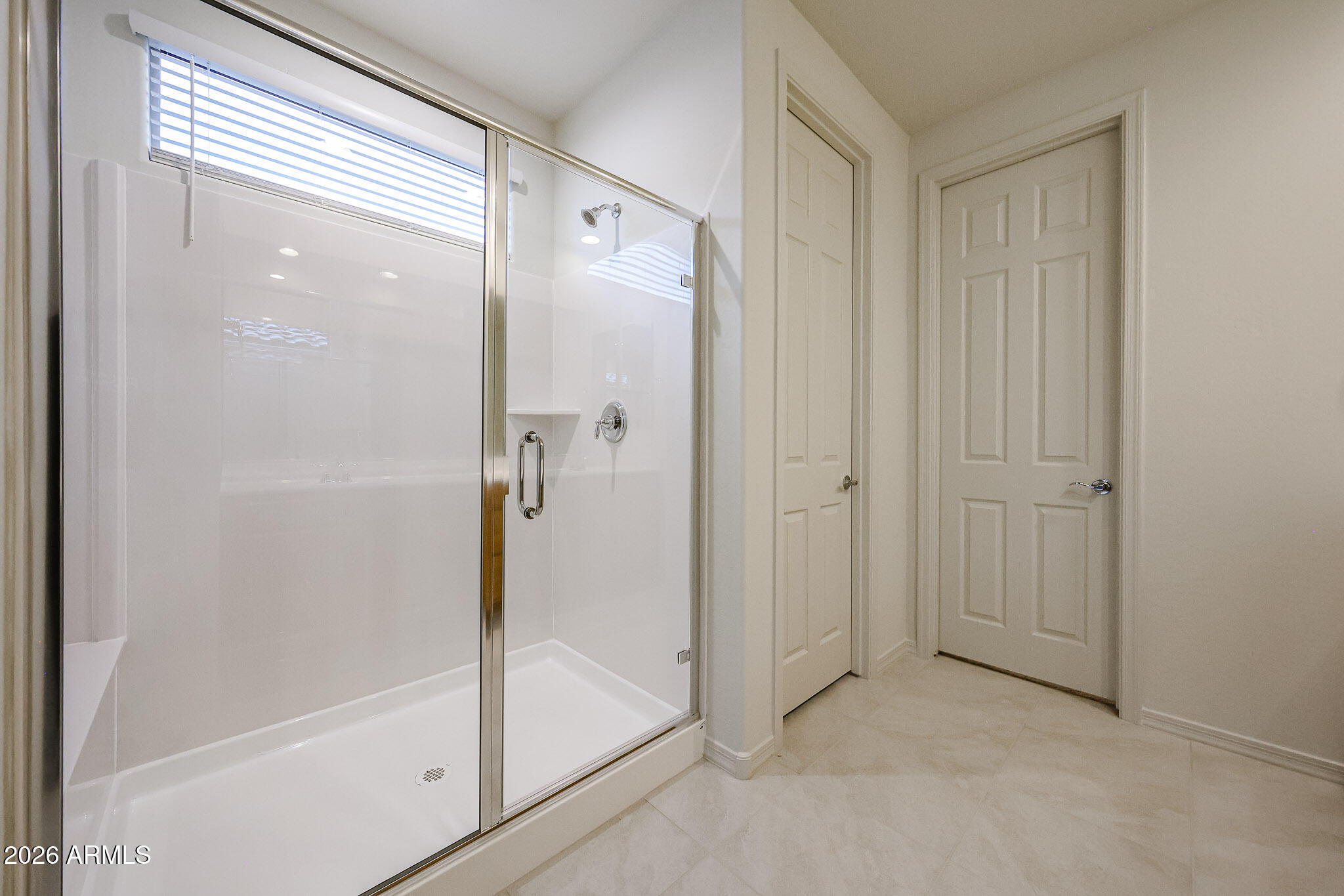 7078 West Plum Road Peoria, AZ 85383 - Photo 11 of 23 a bathroom with a glass shower door