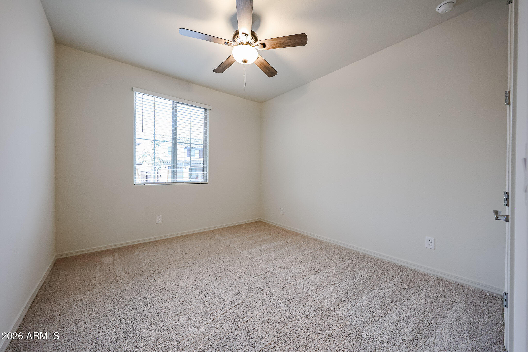 7078 West Plum Road Peoria, AZ 85383 - Photo 13 of 23 an empty room with windows and ceiling fan