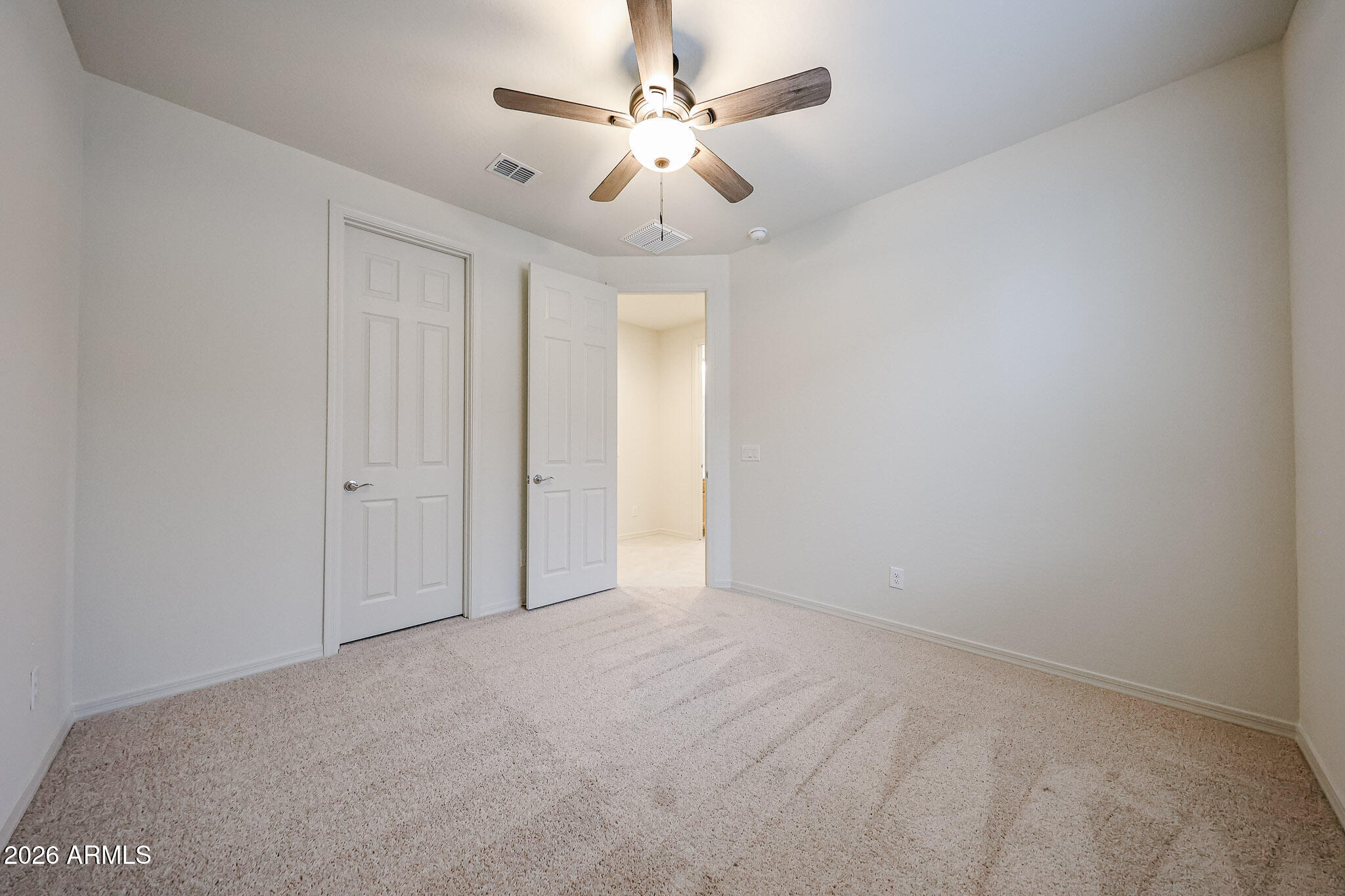 7078 West Plum Road Peoria, AZ 85383 - Photo 14 of 23 en empty room with fan and a ceiling fan
