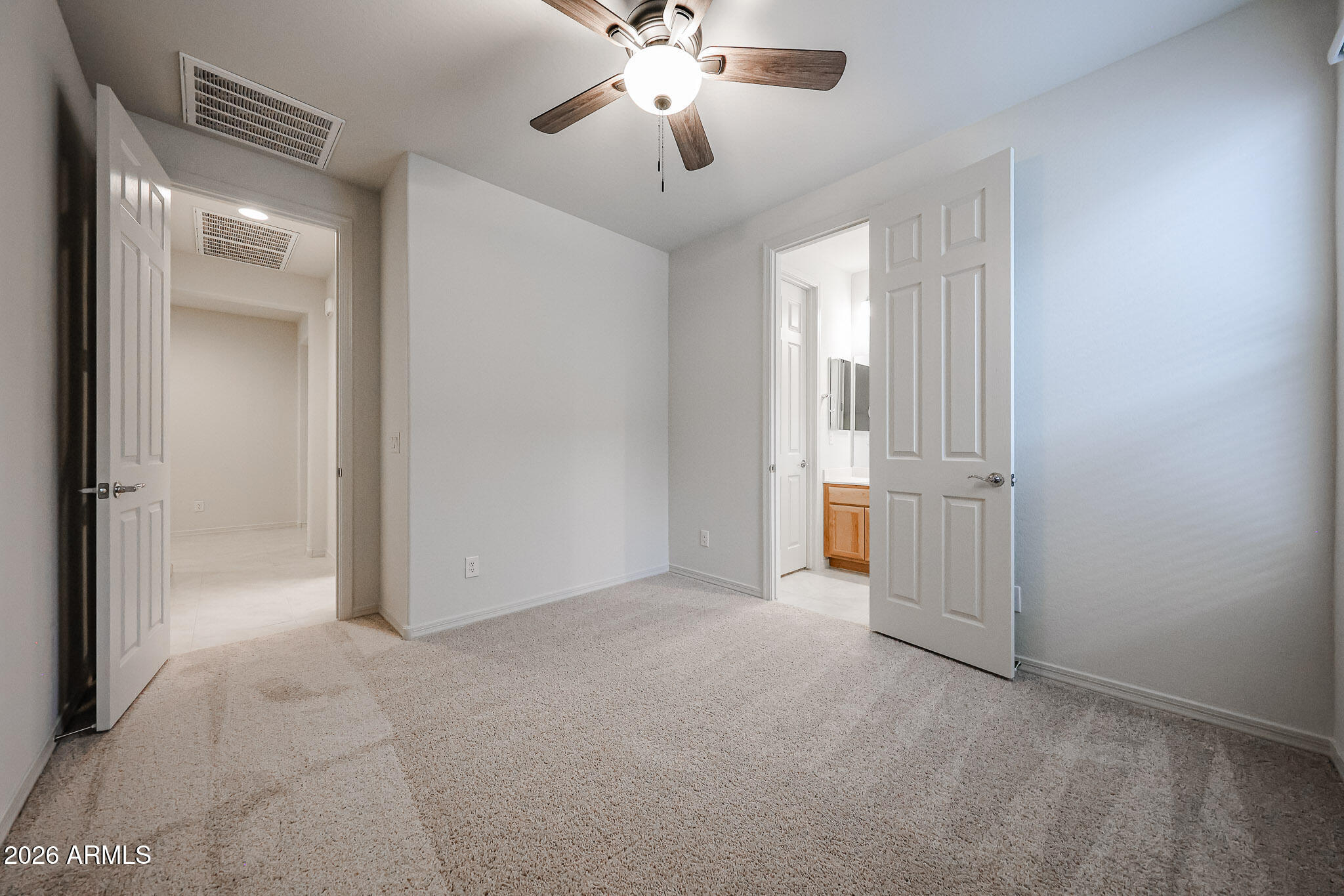 7078 West Plum Road Peoria, AZ 85383 - Photo 16 of 23 a view of a room with a ceiling fan and a bathroom