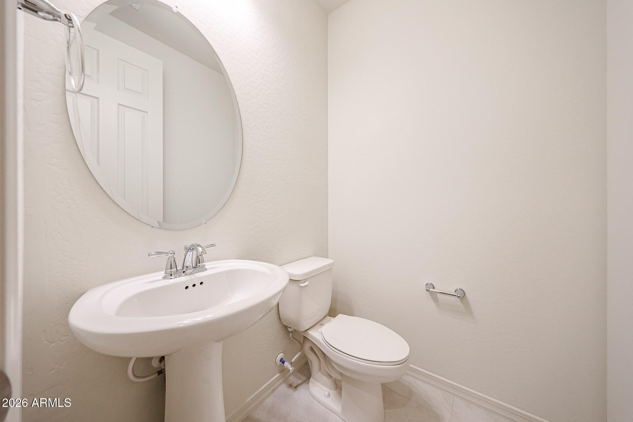 7078 West Plum Road Peoria, AZ 85383 - Photo 19 of 23 a bathroom with a sink and a mirror