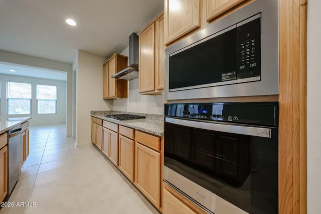 a kitchen with stainless steel appliances kitchen island granite countertop a stove microwave and sink