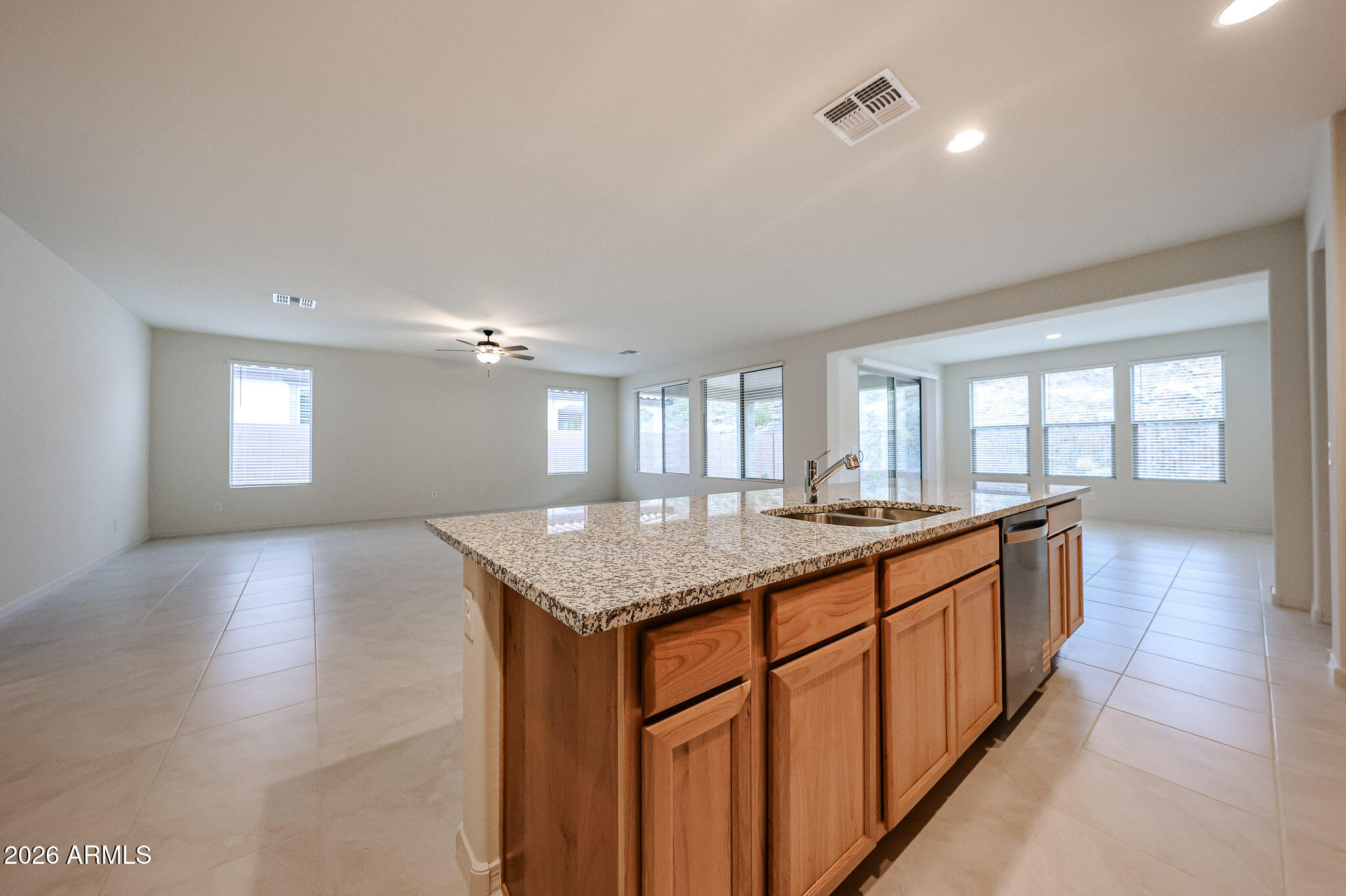 7078 West Plum Road Peoria, AZ 85383 - Photo 4 of 23 a large kitchen with kitchen island granite countertop a large window