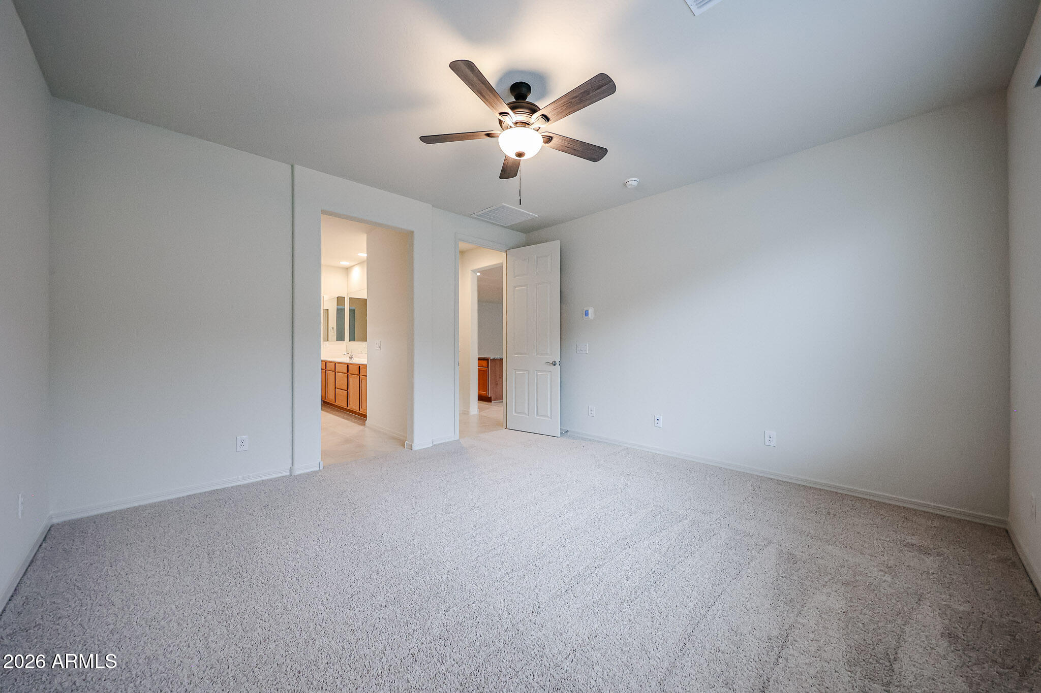 7078 West Plum Road Peoria, AZ 85383 - Photo 8 of 23 an empty room with closet and ceiling fan