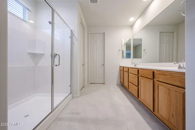 a bathroom with a tub shower and sink