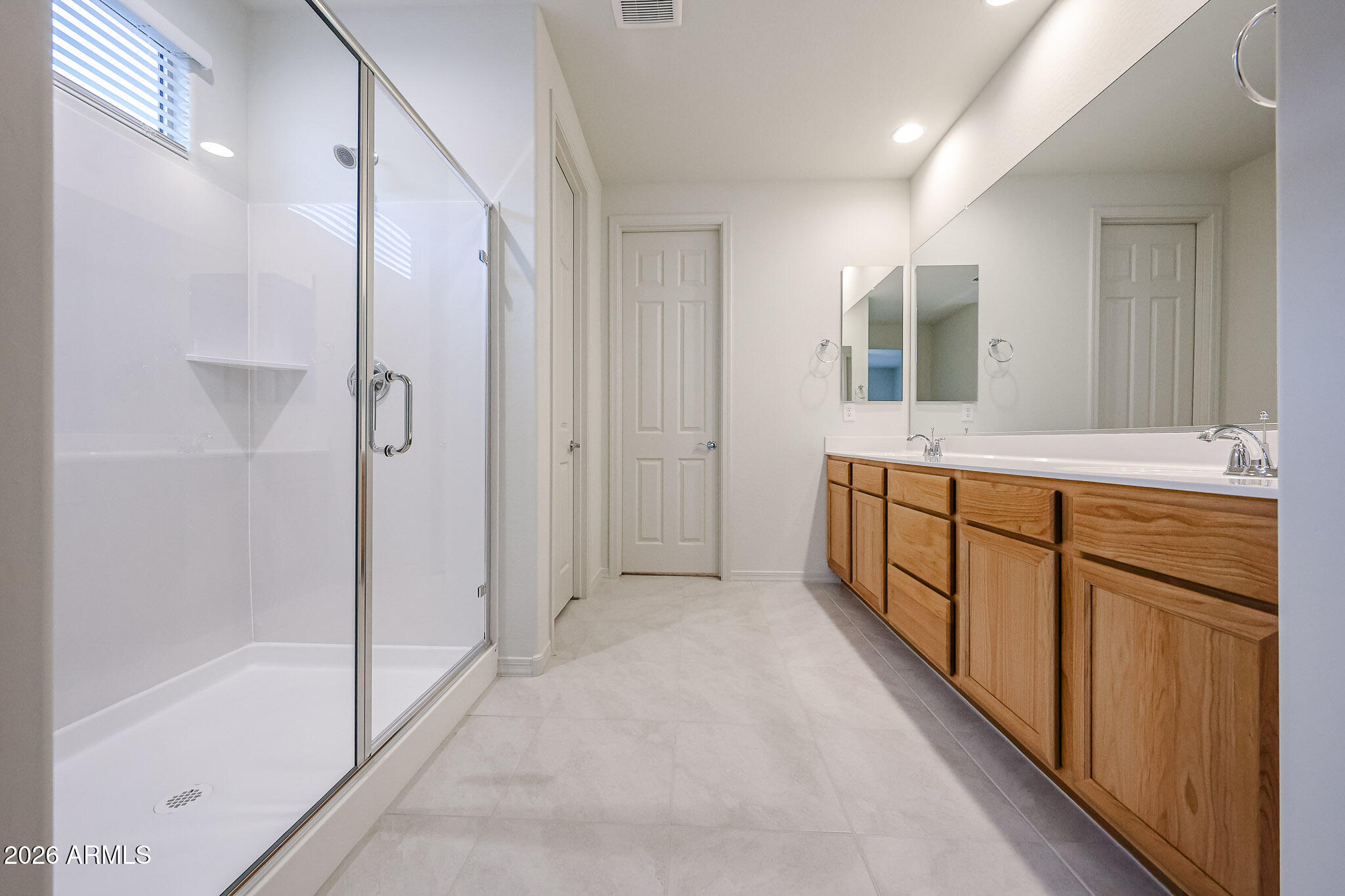 7078 West Plum Road Peoria, AZ 85383 - Photo 10 of 23 a bathroom with a tub shower and sink