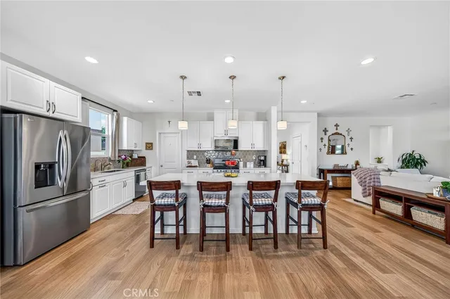 a large white kitchen with lots of counter space and windows