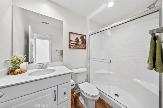 a bedroom with a bed and a lamp on the dresser