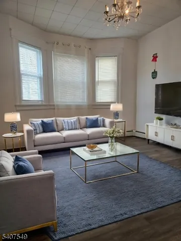 a bedroom with a large bed lamp and a potted plant