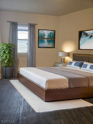 a spacious bedroom with a bed and wooden floor