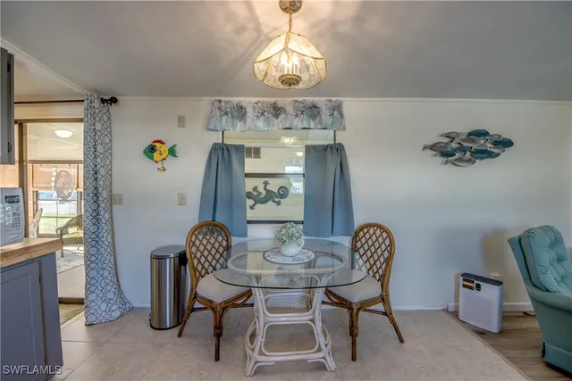 a kitchen with a dining table chairs cabinets and stainless steel appliances